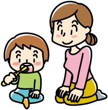 座って歯みがきをする子供と見守る親